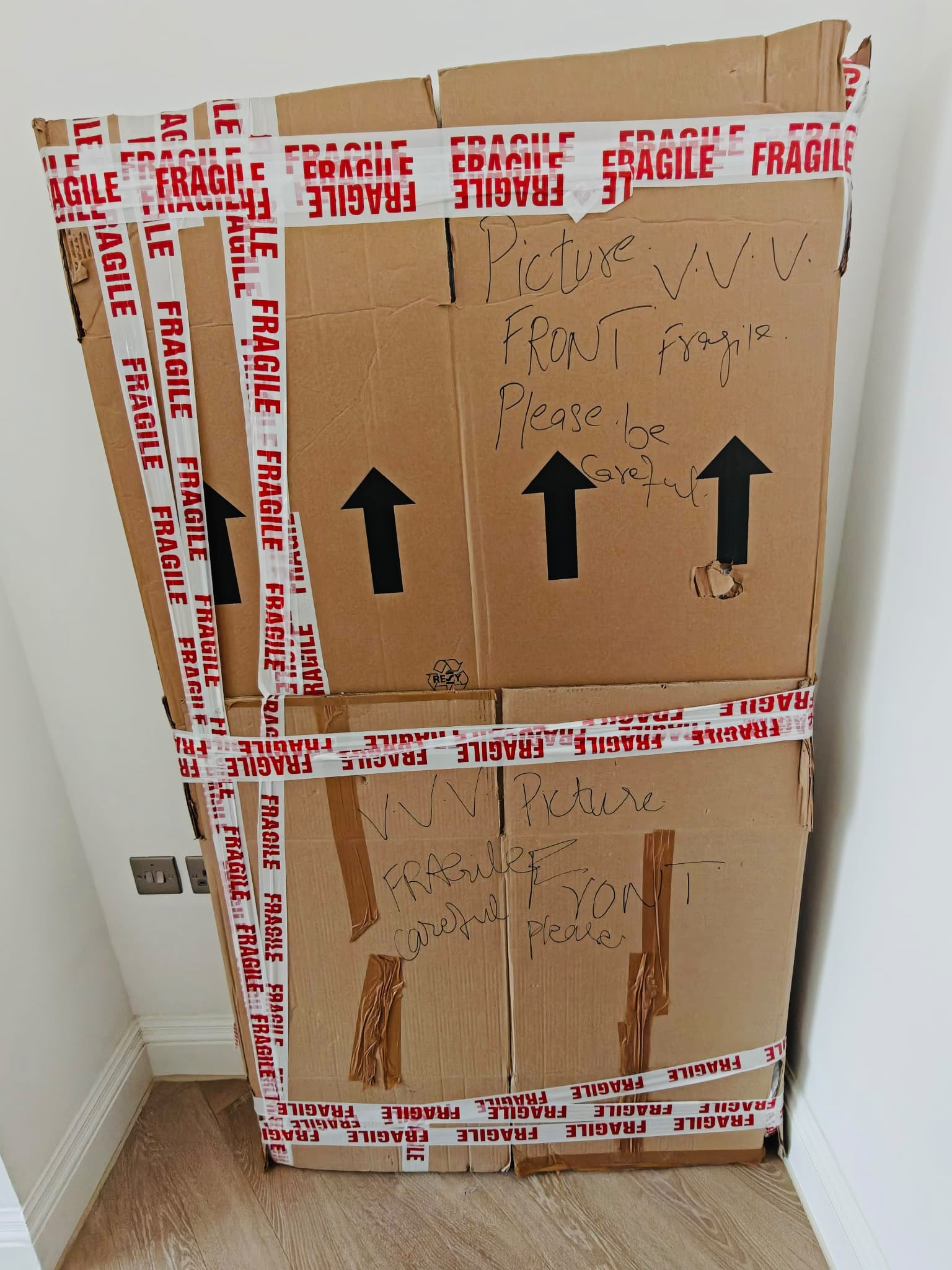 Fragile-taped cartons labelled by hand with their contents