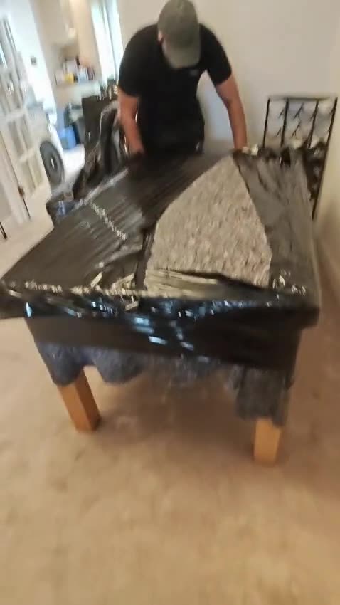 A table wrapped and eased onto a trolley
