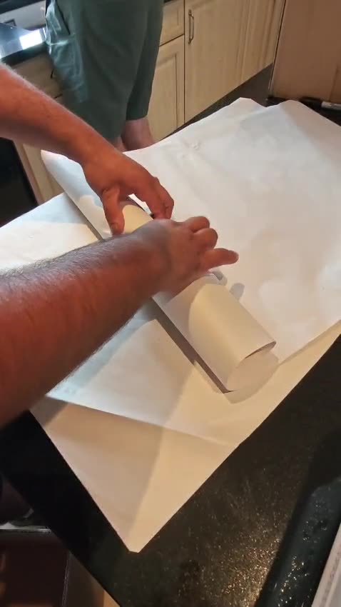 Glassware wrapped by hand in packing paper